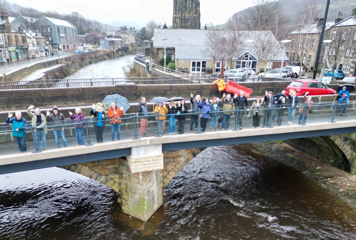 Representatives from Calderdale Council, West Yorkshire Combined Authority, Jackson Civil Engineering, and the local community gathered for Mytholmroyd footbridge official opening.