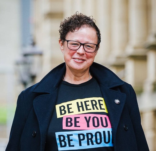 Councillor Sarah Courtney, Calderdale Council’s Cabinet Member for Regeneration and Transport, wearing a top with the words "Be here, be you, be proud."