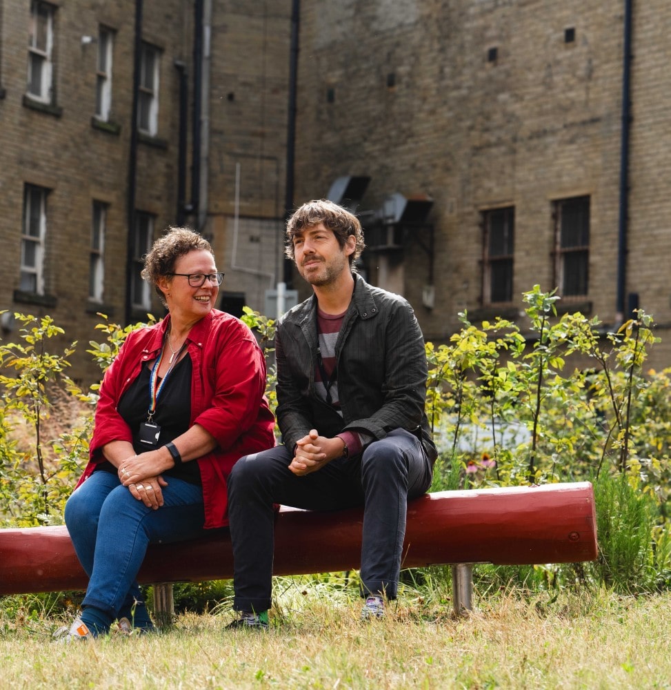 Councillor Courtney and Councillor Patient sit on new seating in Victoria Gardens.