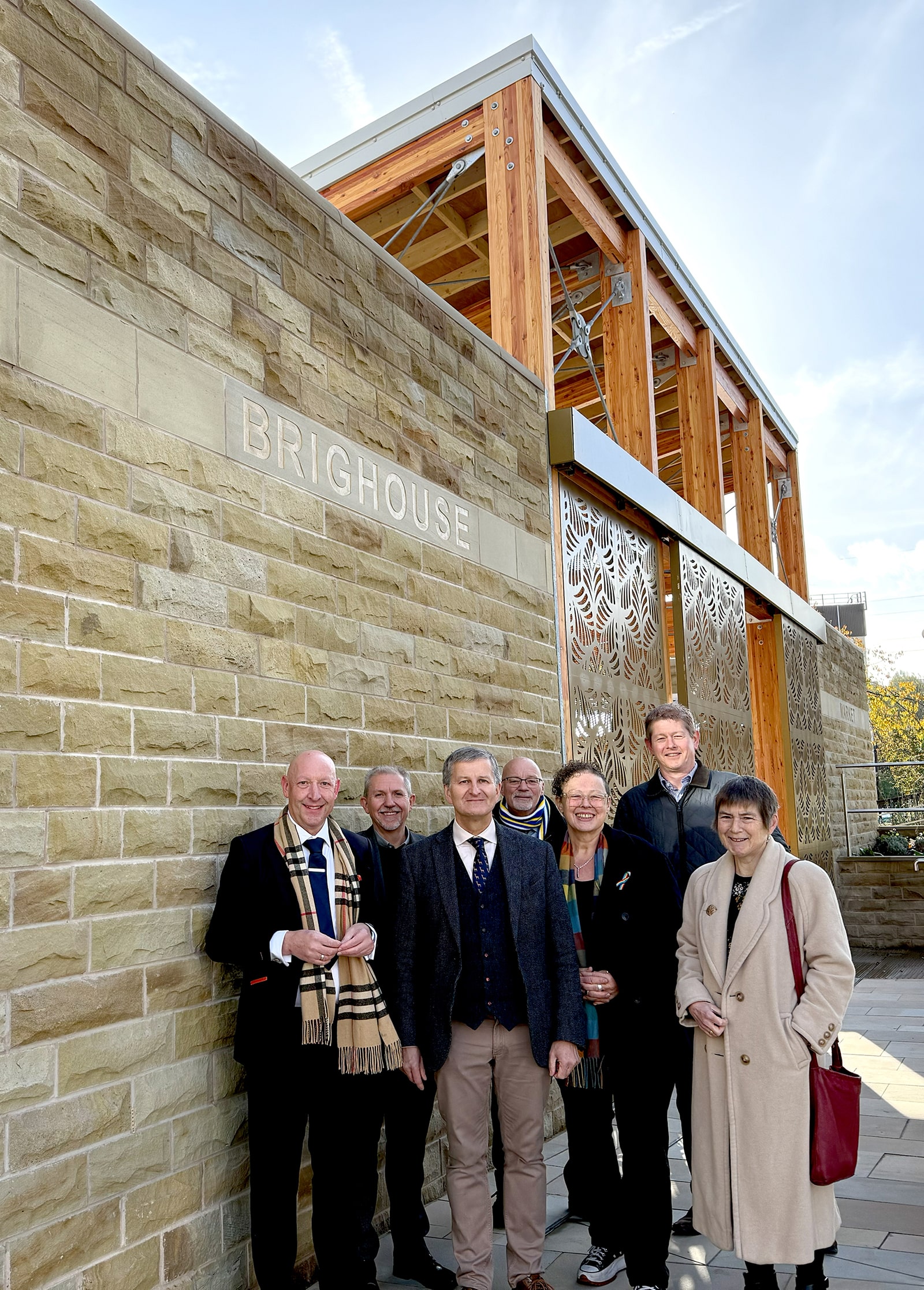 outside the new Brighouse Market with (left to right): Cllr Howard Blagbrough; Paul Clarkson; David Whitehead; John Walker; Cllr Sarah Courtney; Paul McRae; Cllr Silvia Dacre.