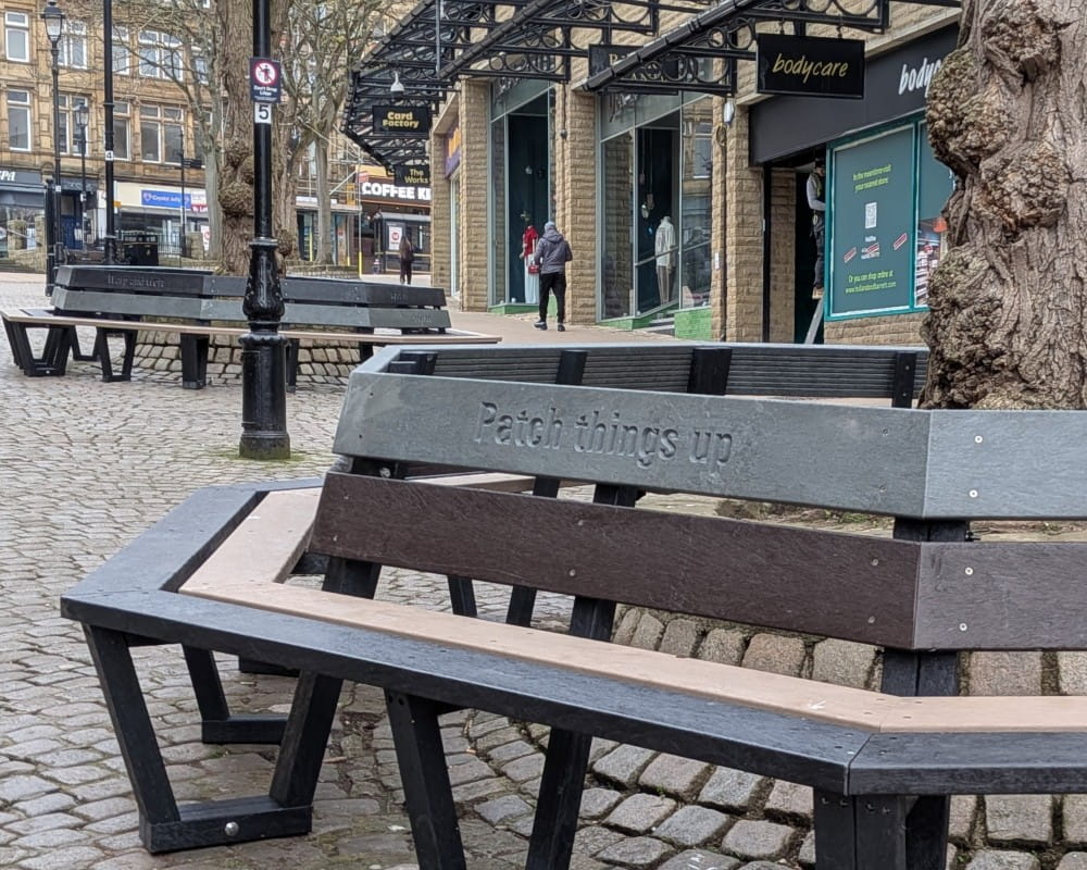 Benches etched with the phrase "Patch things up". 
