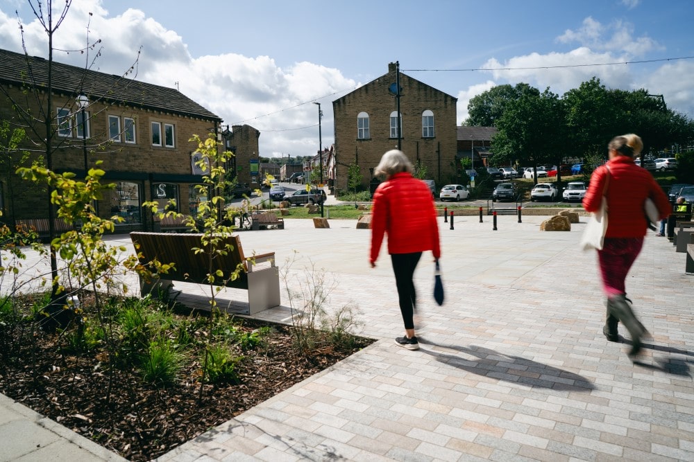 People walk through Southgate Square. The square has new paving, planting, seating, and more space for events.