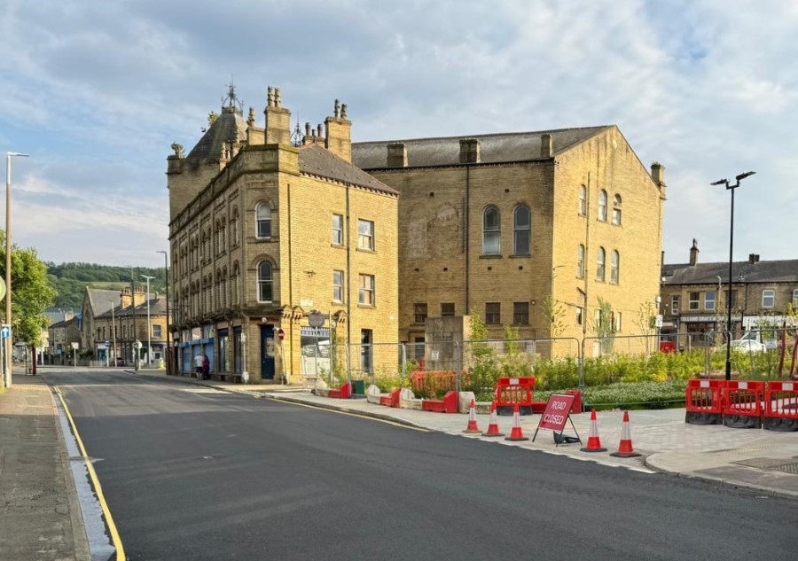 New black road surface and road markings on Huddersfield Road next to the new planting at Victoria Gardens.