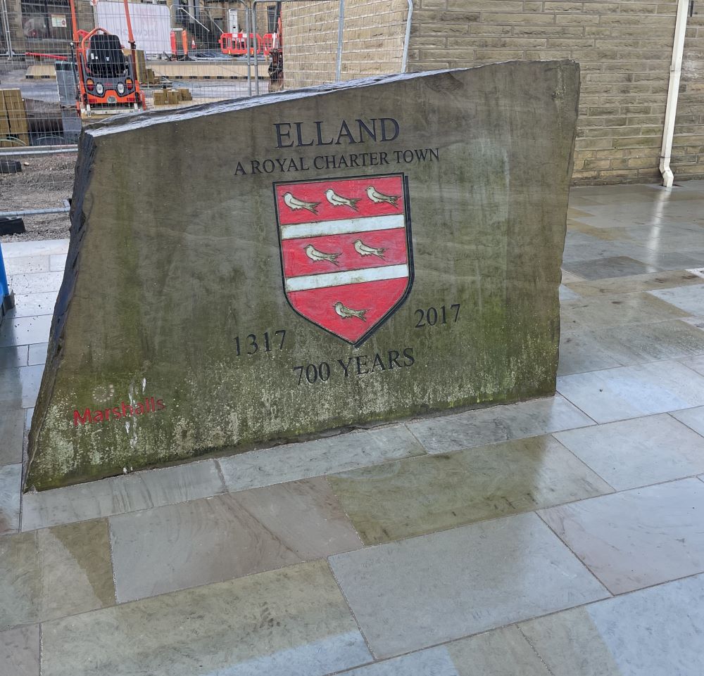 Close-up of paving installation around Elland Rock.